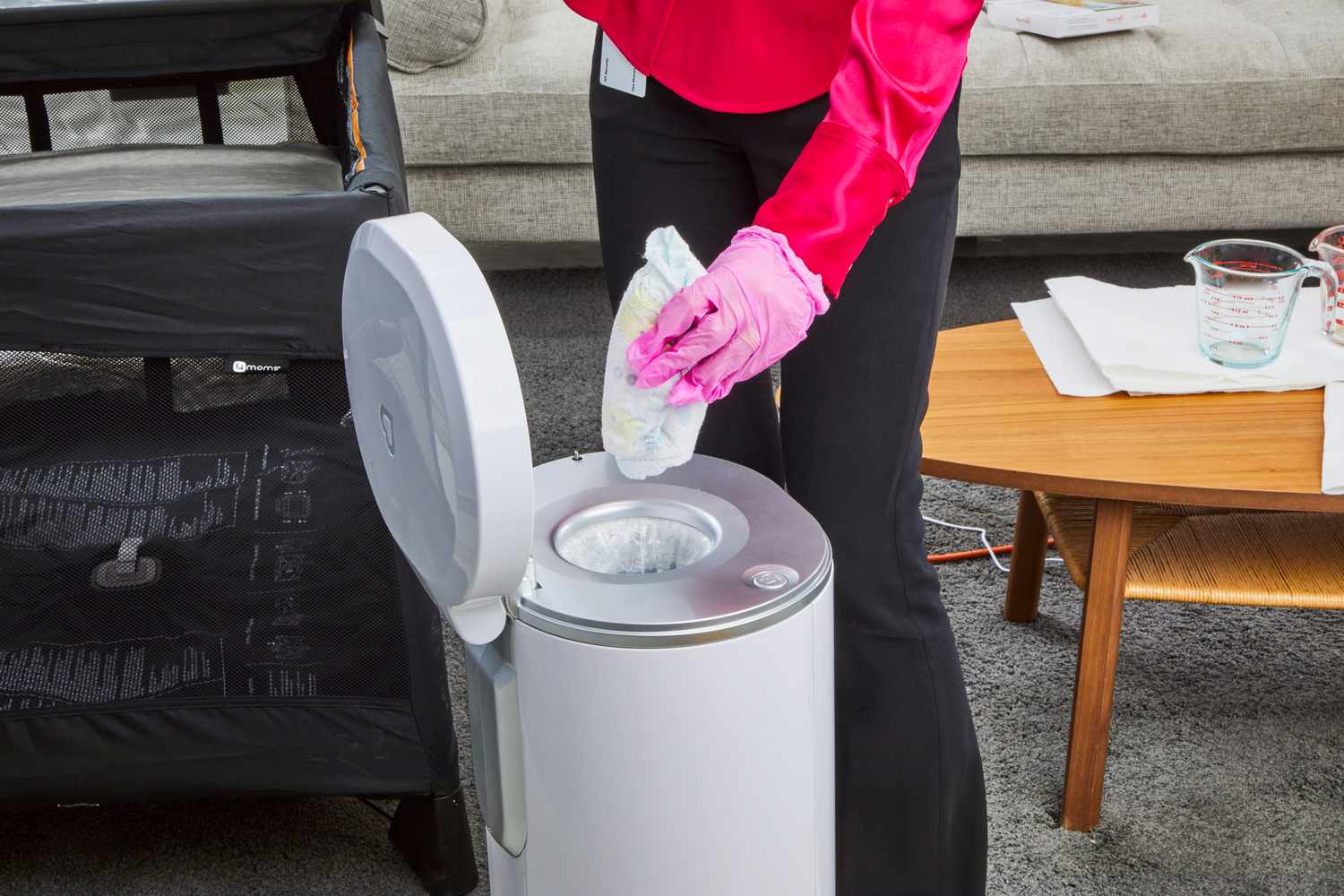 A diaper is placed inside the Munchkin UV Diaper Pail