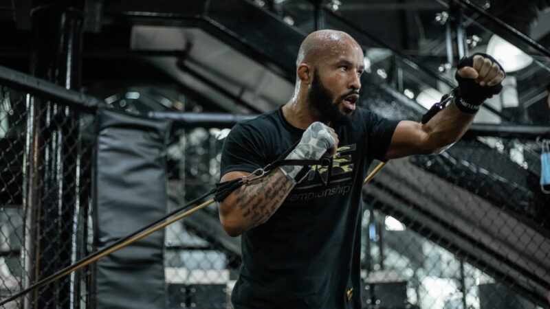 A man doing resisted boxer exercise with resistance bands