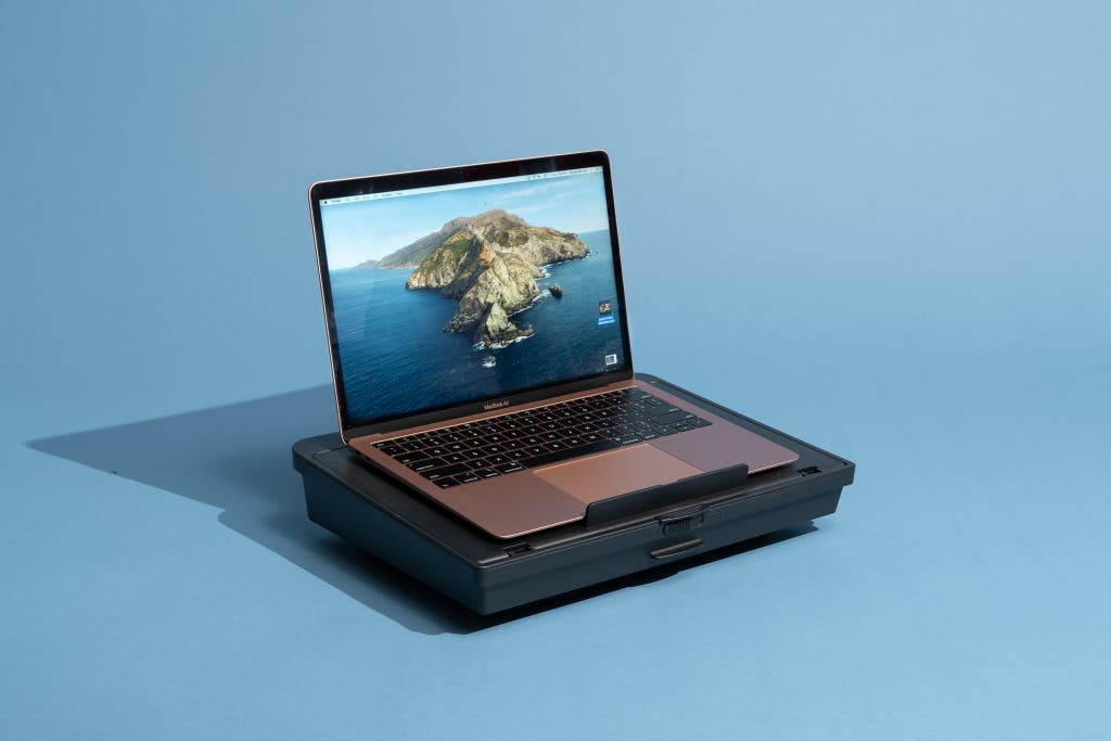 The Huanuo HNLD15 lap desk, our choice for the best lap desk for travel, shown in black holding an open laptop computer.